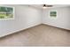 Neutral toned bedroom featuring hardwood floors and natural light from dual windows at 30 N Cleveland Church Rd, Mcdonough, GA 30253