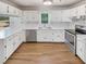 Bright kitchen features stainless steel appliances, white cabinets, and hardwood floors at 30 N Cleveland Church Rd, Mcdonough, GA 30253