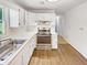 Bright kitchen features white cabinets, stainless steel oven, laminate counters and wood-look flooring at 30 N Cleveland Church Rd, Mcdonough, GA 30253