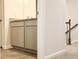 Bathroom vanity with granite countertop next to a carpeted staircase at 631 Egrets Lot 50 Lndg, Covington, GA 30014