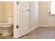 Half-bathroom featuring neutral wall paint and wood flooring, next to the front entry way at 631 Egrets Lot 50 Lndg, Covington, GA 30014