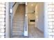 Inviting entryway with staircase and wood-look floors leading to a living space at 631 Egrets Lot 50 Lndg, Covington, GA 30014