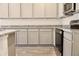 Kitchen with granite countertops, stainless steel appliances, and gray cabinetry at 631 Egrets Lot 50 Lndg, Covington, GA 30014