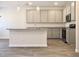 Bright kitchen featuring modern pendant lighting, stainless steel appliances, and gray cabinets at 631 Egrets Lot 50 Lndg, Covington, GA 30014