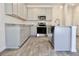Modern kitchen with granite countertops, stainless steel appliances, and gray cabinetry at 631 Egrets Lot 50 Lndg, Covington, GA 30014
