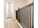 Carpeted staircase with dark wood and black metal railing, leading to the upstairs area at 631 Egrets Lot 50 Lndg, Covington, GA 30014