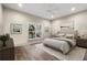 Main bedroom with hardwood floors and large window at 1780 Habersham Villa Dr, Cumming, GA 30041