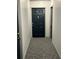 Inviting entry hall with dark-colored door and grey carpet at 1280 W Peachtree Nw St # 1013, Atlanta, GA 30309