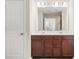 Double vanity bathroom featuring dark wood cabinets, white countertop and chrome fixtures at 3372 Baylor Cir, Mcdonough, GA 30253