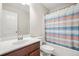 Bathroom featuring vanity, toilet, and shower/tub with a stylish striped curtain at 3372 Baylor Cir, Mcdonough, GA 30253