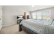 Bedroom featuring neutral walls and carpet, a large window and a tv on an entertainment center at 3372 Baylor Cir, Mcdonough, GA 30253