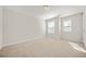 Bedroom featuring neutral carpeting, light walls, and two windows for great natural light at 3372 Baylor Cir, Mcdonough, GA 30253