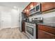 Well-equipped kitchen with stainless steel appliances, wood cabinets, and granite countertops at 3372 Baylor Cir, Mcdonough, GA 30253