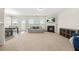 Spacious carpeted living room with a fireplace, large windows, and neutral decor at 3372 Baylor Cir, Mcdonough, GA 30253