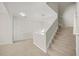 Carpeted stairway in a light color with white walls and wood banister leading to second floor at 3372 Baylor Cir, Mcdonough, GA 30253