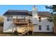 A two-story house with a back deck and staircase is accented by white siding and a dark roof at 2961 Rolling Ln, Winston, GA 30187