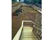 Spacious backyard with a wooden fence, garden beds, and a staircase leading to the upper level at 2961 Rolling Ln, Winston, GA 30187