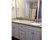 Bathroom featuring a double vanity with granite countertops, white cabinets, and chrome hardware at 2961 Rolling Ln, Winston, GA 30187