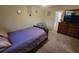 Comfortable bedroom featuring a bed with patterned bedding, a side chair, and dresser at 2961 Rolling Ln, Winston, GA 30187