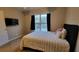Bedroom with plush carpeting, a large window, and a mounted television at 2961 Rolling Ln, Winston, GA 30187