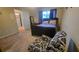 Cozy bedroom featuring a black bed frame and chair with patterned accents near the doorway at 2961 Rolling Ln, Winston, GA 30187