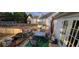Back deck area with a table, chairs, potted plants, and an umbrella, perfect for outdoor entertaining at 2961 Rolling Ln, Winston, GA 30187