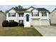 Charming two-story home with a well-manicured lawn, attached garage, and inviting blue front door at 2961 Rolling Ln, Winston, GA 30187