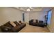 Inviting living room showcasing comfortable brown sofas, neutral walls, and a ceiling fan at 2961 Rolling Ln, Winston, GA 30187