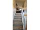 Staircase featuring plush carpet leading to an open and bright living space with vaulted ceilings at 2961 Rolling Ln, Winston, GA 30187