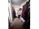 Organized walk-in closet with hanging clothes and shelving for efficient storage solutions at 2961 Rolling Ln, Winston, GA 30187