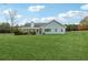 Spacious backyard features a large lawn, mature trees, and detached shed at 3825 Green Ave, Loganville, GA 30052