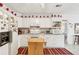 Bright kitchen with white cabinets, island, and stainless steel appliances at 3825 Green Ave, Loganville, GA 30052