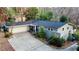 Aerial view of the home with well-maintained landscaping, a long driveway, and a two-car garage at 3479 Chestnut Dr, Atlanta, GA 30340