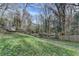 This backyard has mature trees and a lush green lawn, providing a tranquil setting at 3479 Chestnut Dr, Atlanta, GA 30340