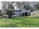 View of the back of the house from the backyard with a deck and grass at 3479 Chestnut Dr, Atlanta, GA 30340