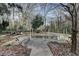Outdoor entertainment space featuring a picnic table, grill, and stone wall at 3479 Chestnut Dr, Atlanta, GA 30340