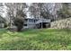 This backyard features a house with a deck and a retaining wall at 3479 Chestnut Dr, Atlanta, GA 30340