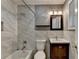 Bathroom featuring marble-style tile, updated vanity and a shower/tub combo at 3479 Chestnut Dr, Atlanta, GA 30340