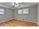 Bedroom featuring hardwood flooring, neutral paint, a ceiling fan and two windows at 3479 Chestnut Dr, Atlanta, GA 30340