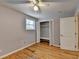 Bedroom with hardwood flooring, ceiling fan, closet with folding doors and a large window at 3479 Chestnut Dr, Atlanta, GA 30340