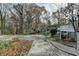 A concrete driveway leads to a house, surrounded by trees and foliage at 3479 Chestnut Dr, Atlanta, GA 30340