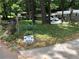 Lush front yard with 'Yard of the Month' sign and mature trees adding curb appeal to the property at 3479 Chestnut Dr, Atlanta, GA 30340