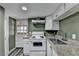 Compact kitchen featuring granite countertops and white appliances at 3479 Chestnut Dr, Atlanta, GA 30340
