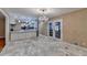 Open kitchen with marble flooring, new appliances, white cabinets and french doors at 3479 Chestnut Dr, Atlanta, GA 30340