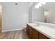 Bathroom with gray walls, wood vanity, and a large mirror at 3562 Ontario Ct, Buford, GA 30519