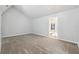 Main bedroom with vaulted ceiling, gray walls, carpet, and access to sunroom at 3562 Ontario Ct, Buford, GA 30519