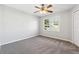 Bright bedroom with gray walls, gray carpet, and a ceiling fan at 3562 Ontario Ct, Buford, GA 30519
