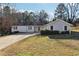 Ranch style home with a landscaped lawn and driveway at 3562 Ontario Ct, Buford, GA 30519