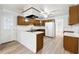 Galley kitchen with wood cabinets, island and new flooring at 3562 Ontario Ct, Buford, GA 30519