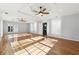 Living room with hardwood floors, high ceilings, and ceiling fans at 3562 Ontario Ct, Buford, GA 30519